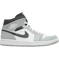Jordan 1 Mid in Light Smoke Grey and white leather with a black Swoosh and iconic Wings logo on the collar.