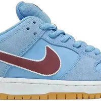 Nike SB Dunk Low Philadelphia Phillies in Valor blue suede with a maroon Swoosh and gum brown sole.