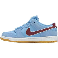 Nike SB Dunk Low Philadelphia Phillies in Valor blue suede with a Team Maroon Swoosh and gum brown rubber sole.