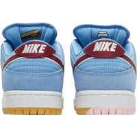Rear view of Nike SB Dunk Low Phillies in Valor blue suede with maroon Swooshes and tongue graphics of a cheesesteak and Liberty Bell.