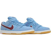 Nike SB Dunk Low Philadelphia Phillies in Valor blue suede with a maroon Swoosh and gum brown sole.