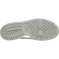 Light grey treaded rubber outsole of the Nike Dunk Low Next Nature GS sneaker with circular pivot point pattern.