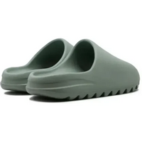 Adidas Yeezy Slide in Salt featuring a monochromatic light green foam construction with a textured, serrated outsole.