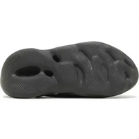 Adidas Yeezy Foam RNR Carbon in a dark grey, one-piece foam design featuring strategic ventilation perforations.